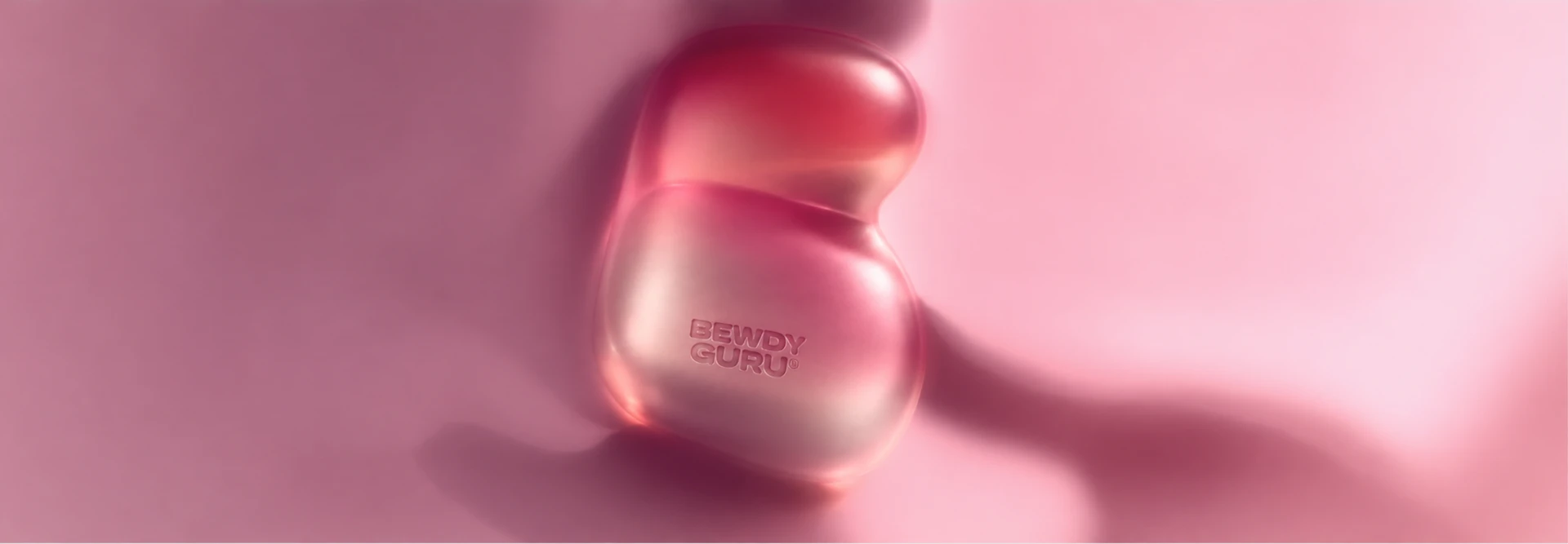 Bewdy Guru device resting on soft pink fabric